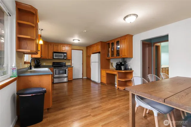 a view of kitchen with cabinets and wooden floor