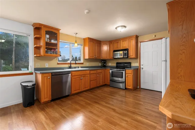 a kitchen with stainless steel appliances granite countertop a stove a sink and a refrigerator