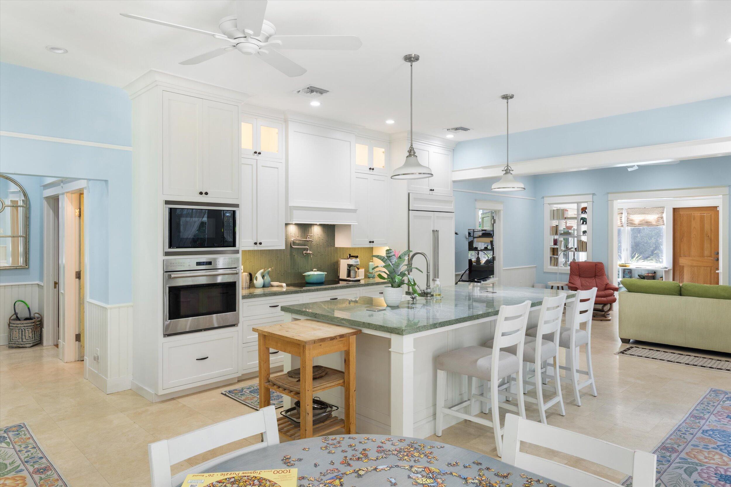 1117 South Street Key West, FL 33040 - Photo 29 of 65 a view of a kitchen with kitchen island stainless steel appliances refrigerator stove dining table and chairs