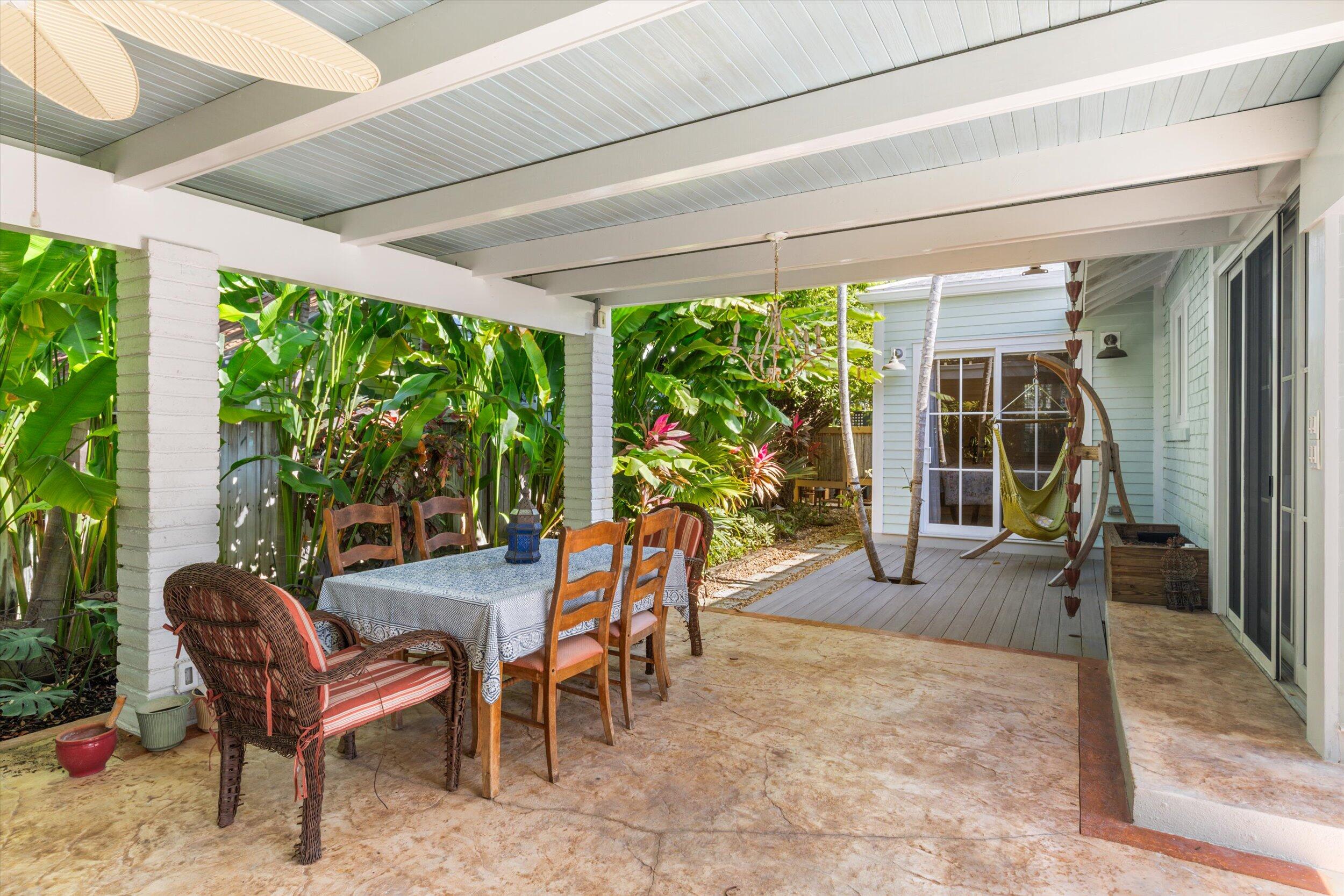 1117 South Street Key West, FL 33040 - Photo 45 of 65 a view of a patio with table and chairs potted plants and floor to ceiling window