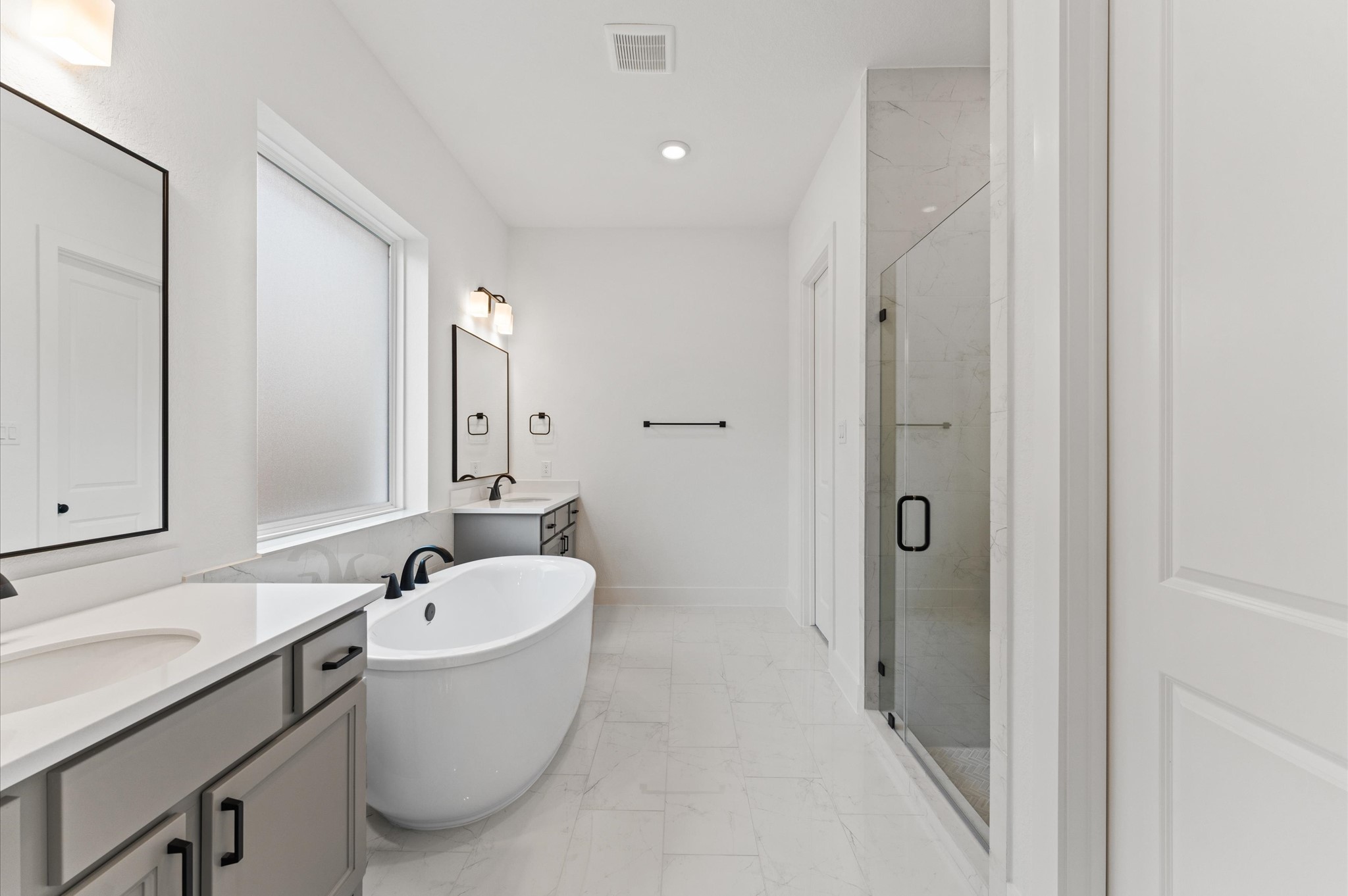 8218 Sherman Pk Trail Spring, TX 77389 - Photo 14 of 28 a bathroom with a white tub a sink and mirror