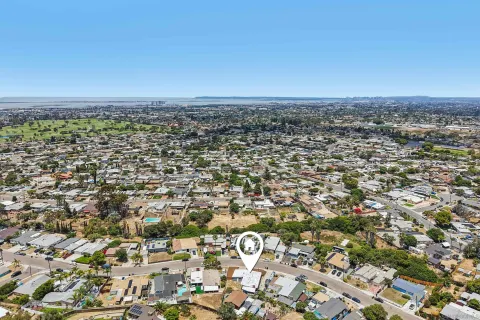 an aerial view of a houses with a city view