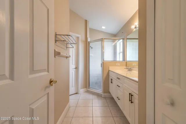 a bathroom with a glass door shower a sink and a mirror