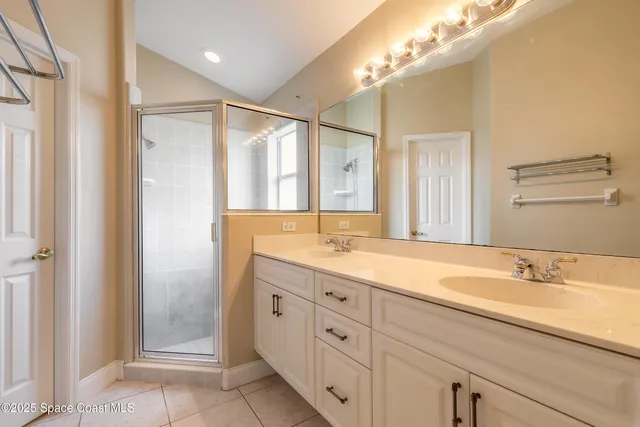 a bathroom with a double vanity sink and a mirror