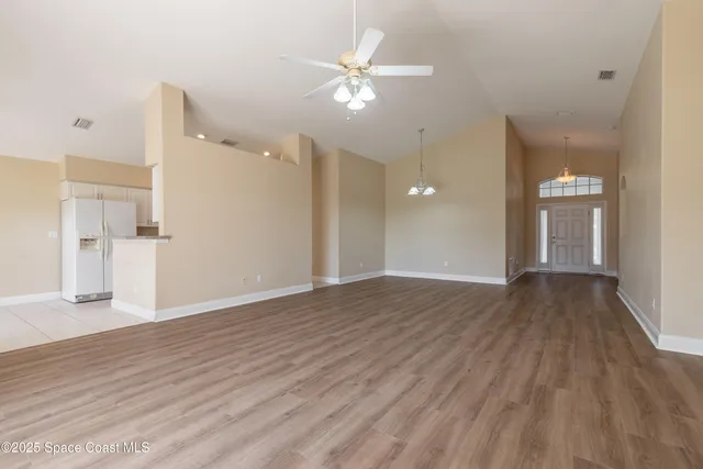 a view of an empty room and wooden floor