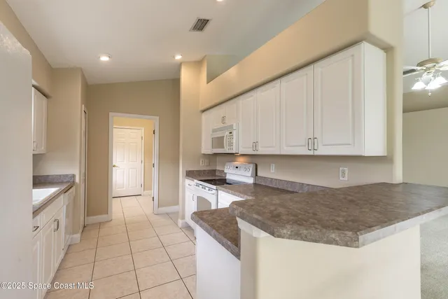 a kitchen with stainless steel appliances granite countertop a sink and cabinets