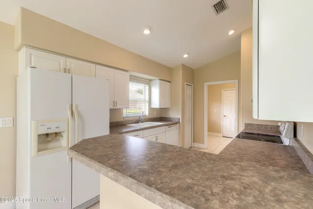 a view of a kitchen cabinets and living room