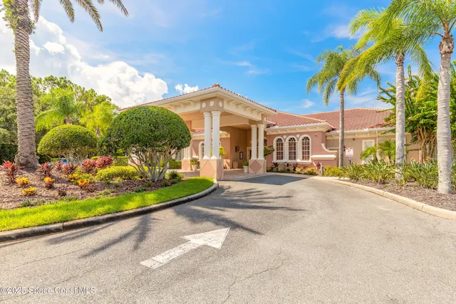 a front view of a house with a garden and trees