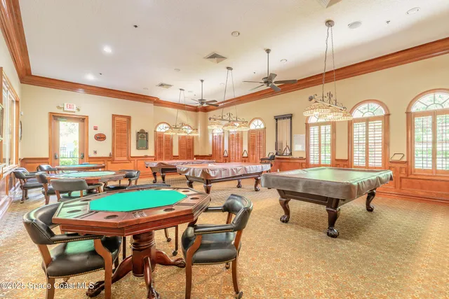 a room with lots of furniture and a chandelier