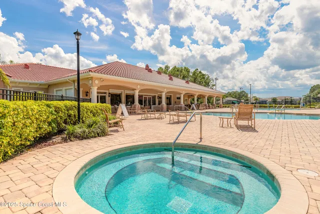 a swimming pool with outdoor seating and yard