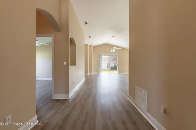 a view of a hallway with wooden floor