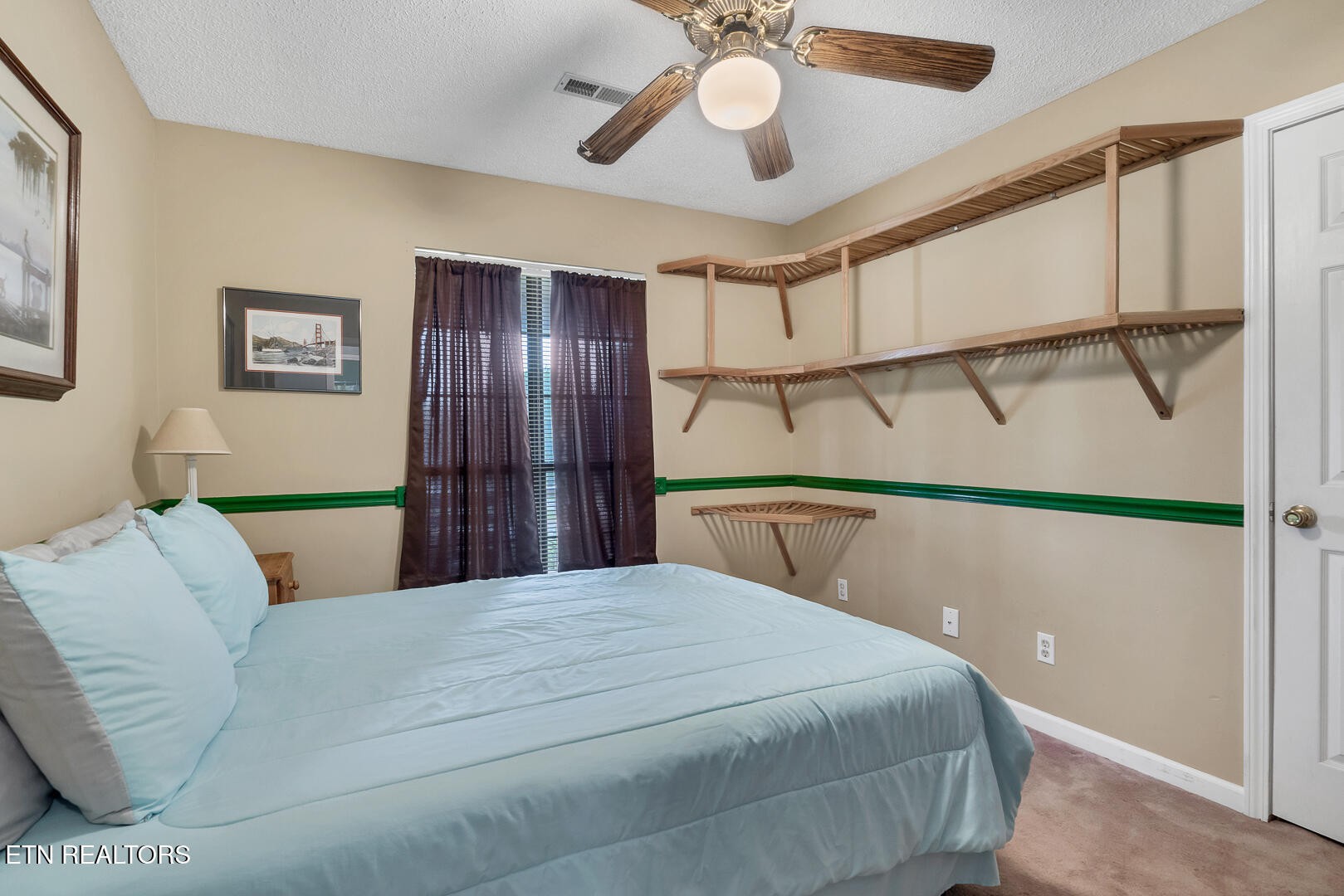 449 Foss Road Maryville, TN 37801 - Photo 30 of 49 a bedroom with a bed mirror and a ceiling fan
