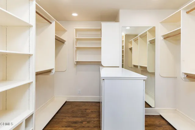 a view of walk in closet with empty racks