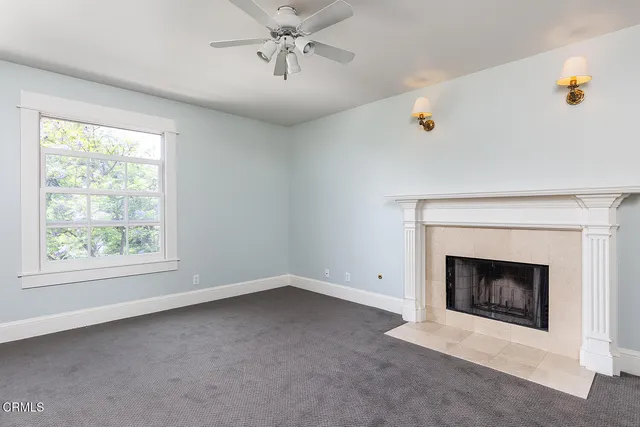 a view of empty room with fireplace