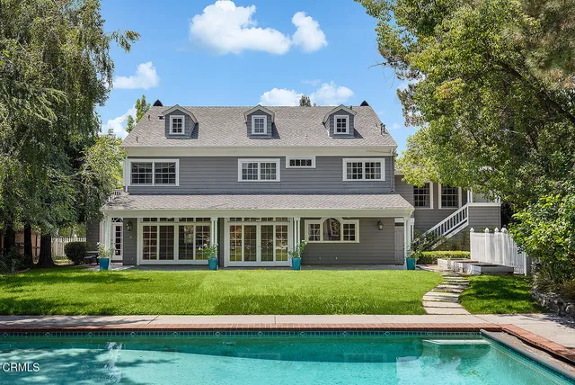 a front view of a house with a yard table and chairs