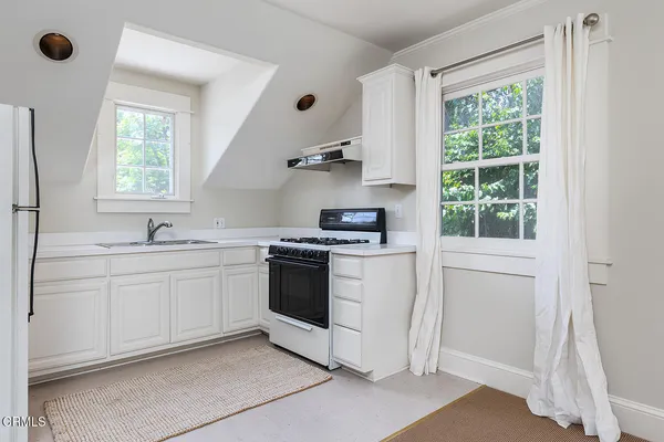 a kitchen with a stove and a sink