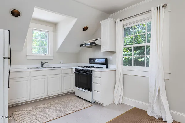 a kitchen with a stove and a sink