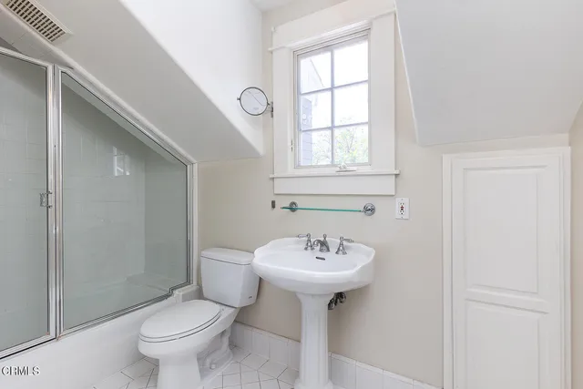 a bathroom with a sink toilet and a mirror