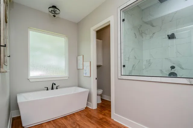 a view of room with window and wooden floor