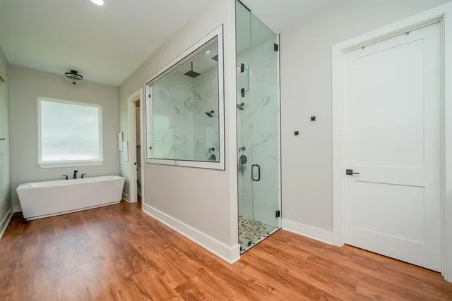 a bathroom with a double vanity sink mirror and shower