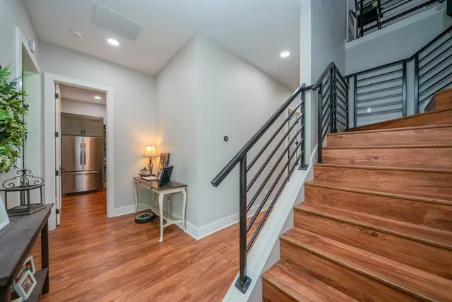 a view of a room with wooden floor and furniture
