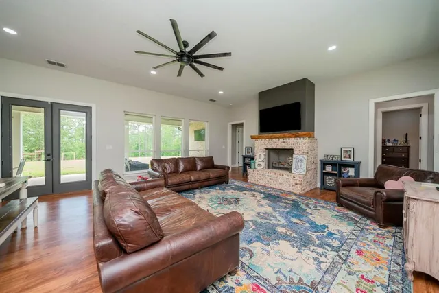 a living room with furniture a flat screen tv and a fireplace