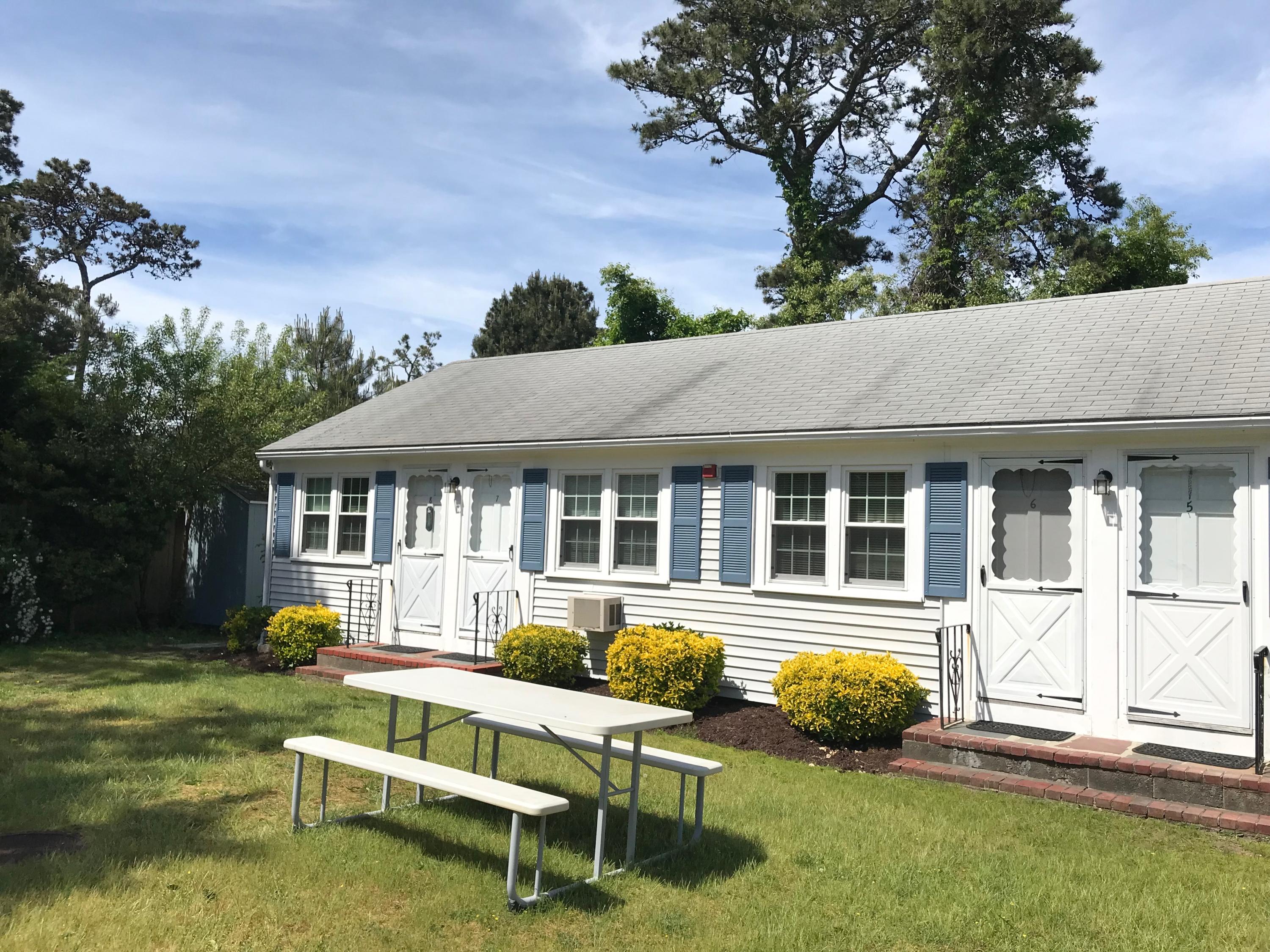 49 Lower County Road, Unit U 7 Dennis Port, MA 02639 - Photo 1 of 23 a house that has sitting area in front of it