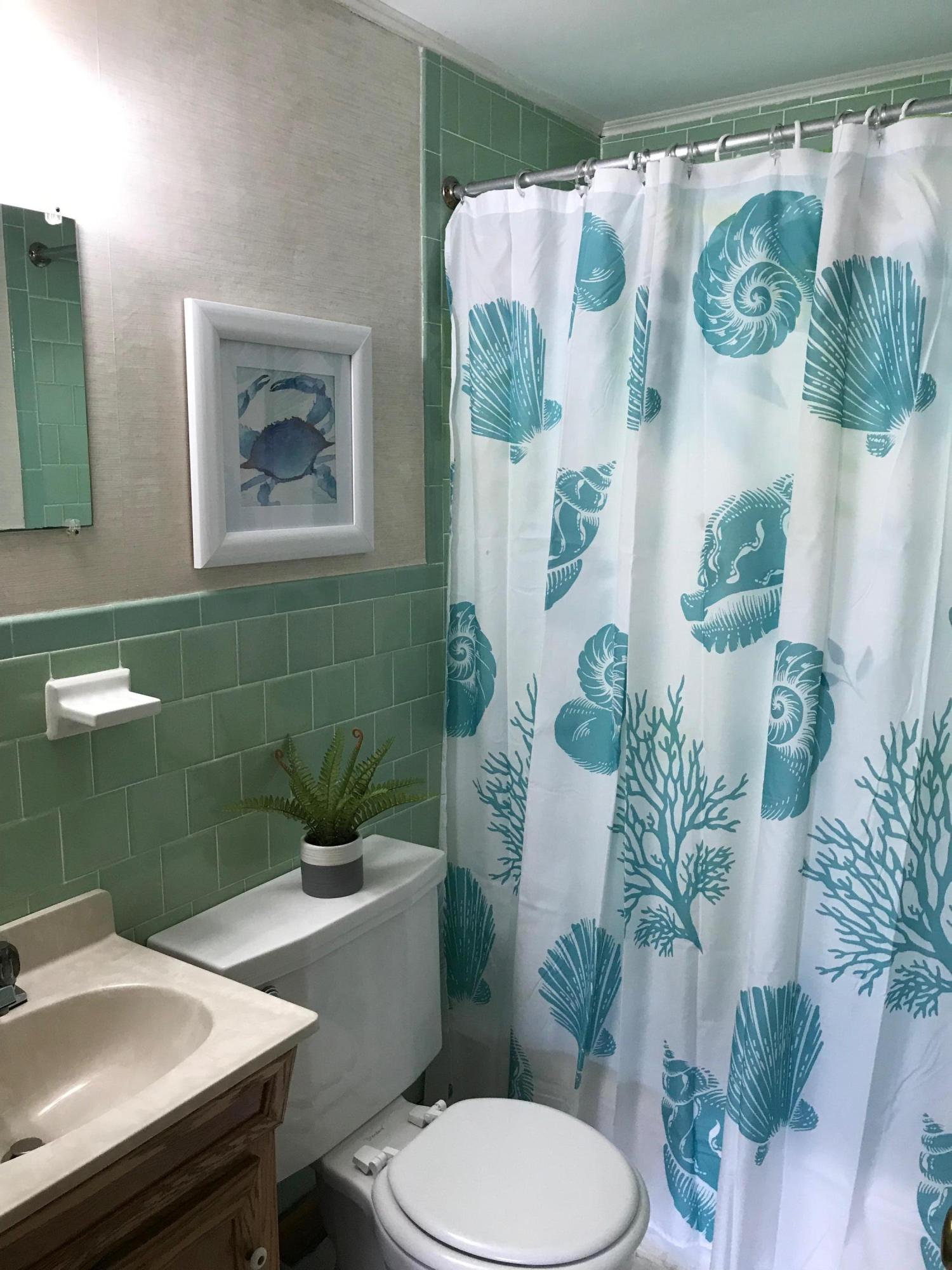 49 Lower County Road, Unit U 7 Dennis Port, MA 02639 - Photo 11 of 23 a bathroom with a toilet and a sink
