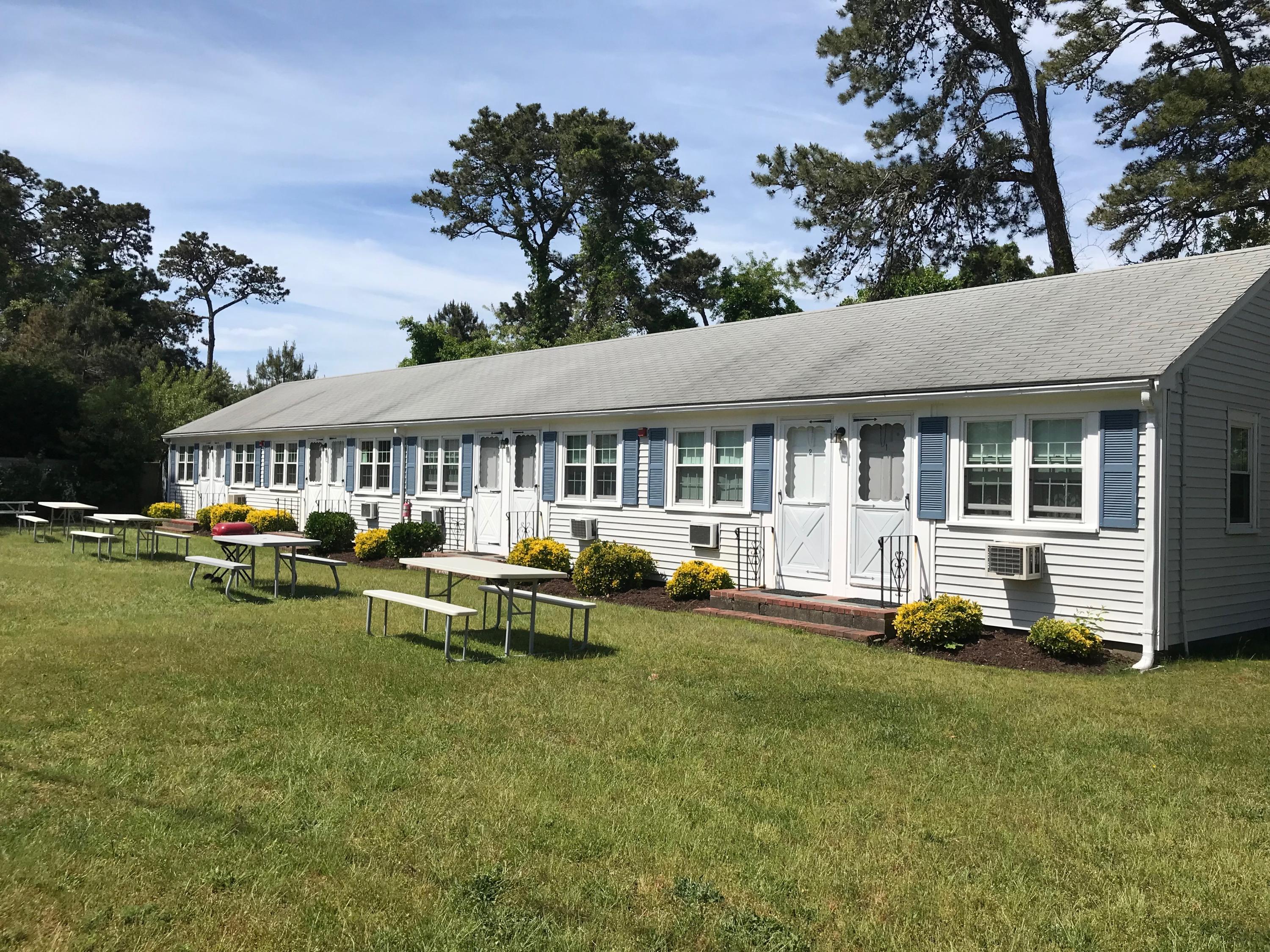 49 Lower County Road, Unit U 7 Dennis Port, MA 02639 - Photo 3 of 23 a view of swimming pool with lawn chairs and a yard
