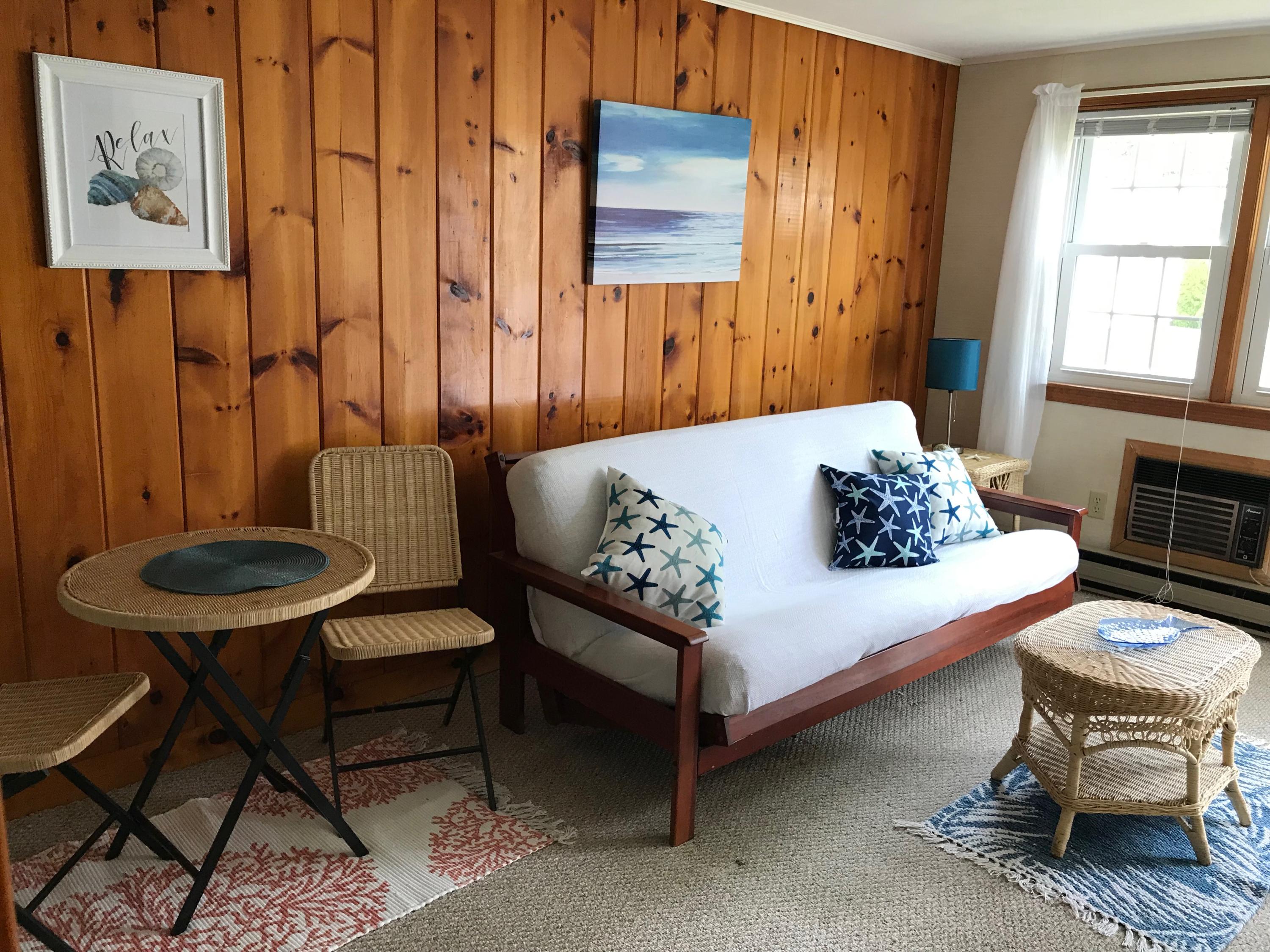 49 Lower County Road, Unit U 7 Dennis Port, MA 02639 - Photo 5 of 23 a bedroom with a bed and a chair