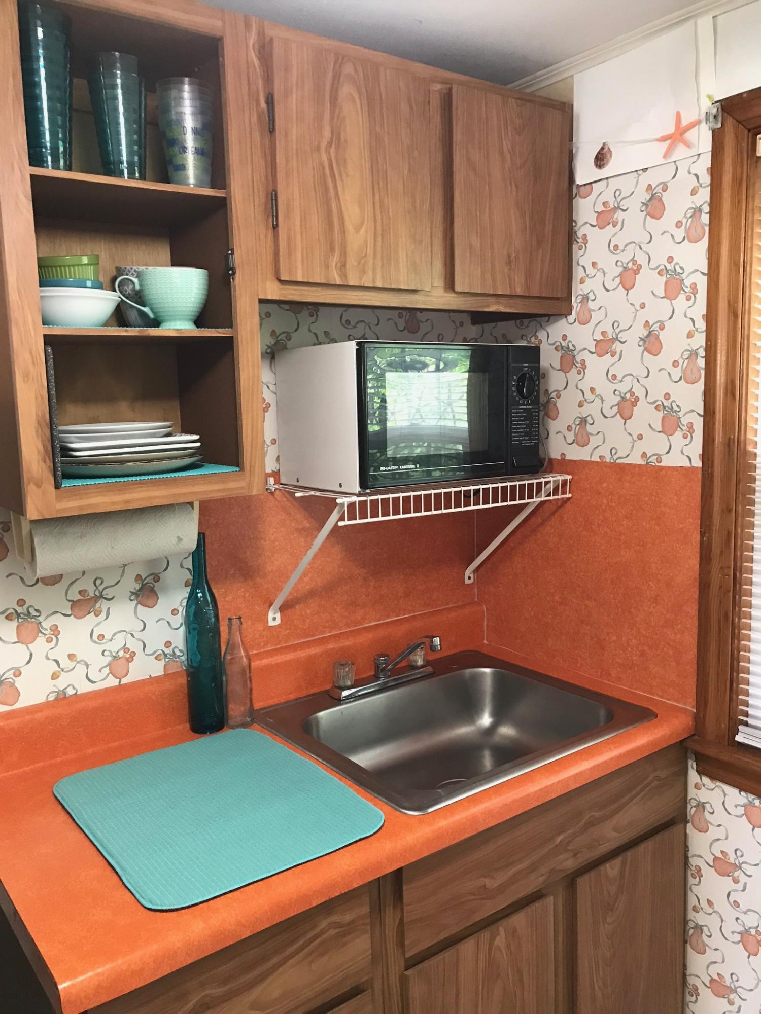 49 Lower County Road, Unit U 7 Dennis Port, MA 02639 - Photo 7 of 23 a kitchen view with granite countertop a sink and a stove