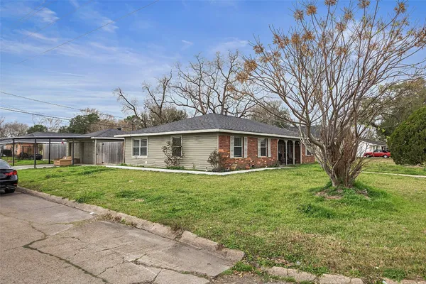 a view of a house with a yard and sitting area