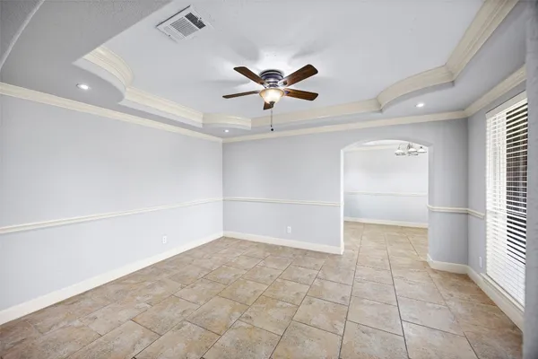 a view of a hallway with chandelier and fire place