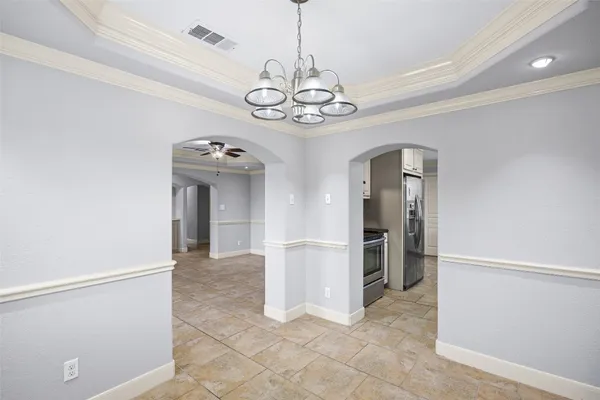 a view of a kitchen with a sink and refrigerator in a room