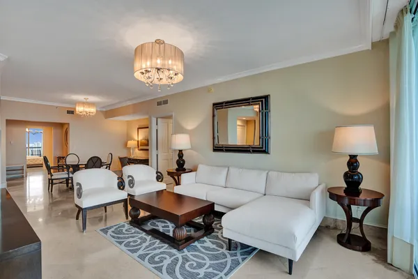 a living room with furniture a lamp and a dining table