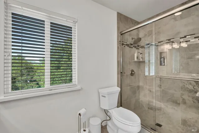 a bathroom with a toilet and a shower