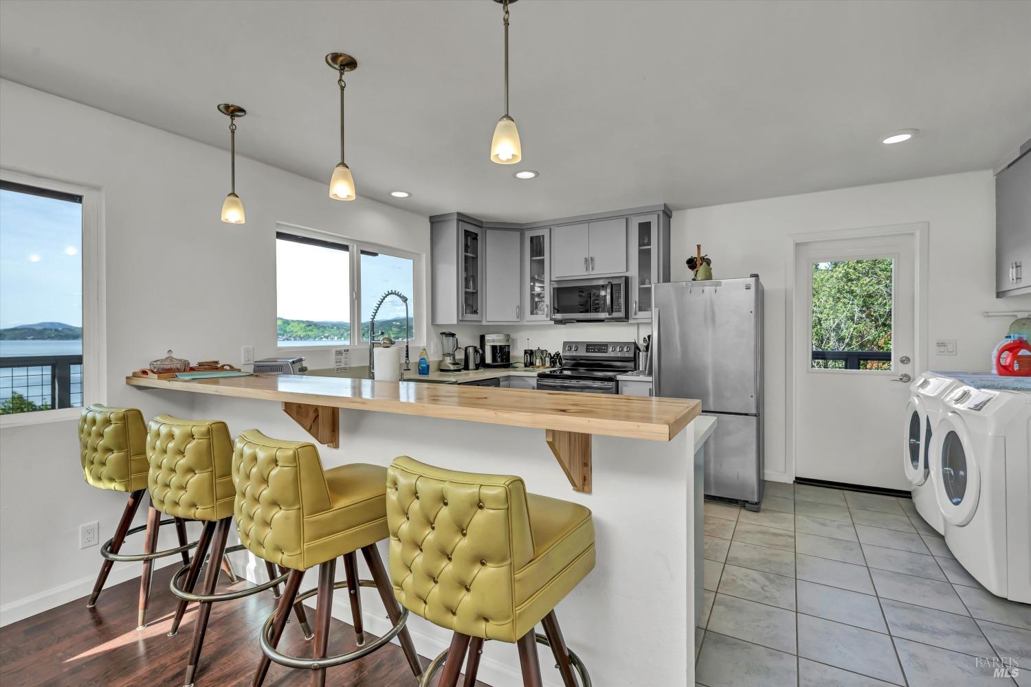 13624 Anderson Road Lower Lake, CA 95457 - Photo 5 of 31 a kitchen with refrigerator and chairs