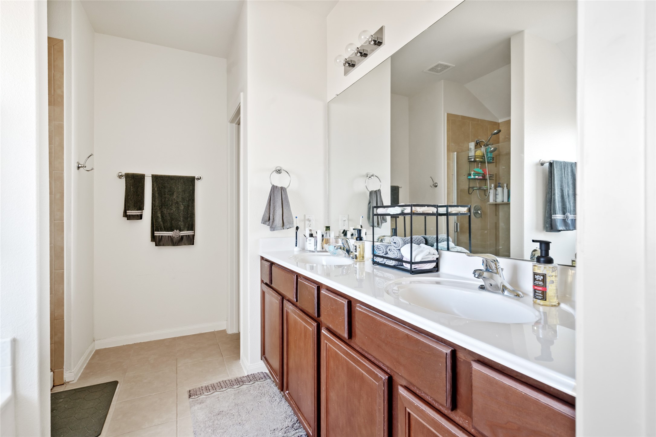 2011 Beach Bluff Road Rosenberg, TX 77469 - Photo 23 of 34 This bathroom offers a clean, functional space with modern fixtures and plenty of storage. Whether for a quick refresh or a relaxing retreat, it combines convenience with comfort, featuring a stylish design and a calming atmosphere.