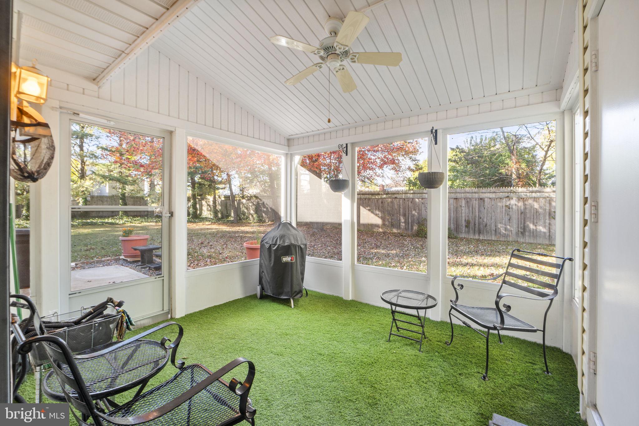 9268 Cherry Lane, Unit 62 Laurel, MD 20708 - Photo 11 of 23 a living room with patio furniture and a garden