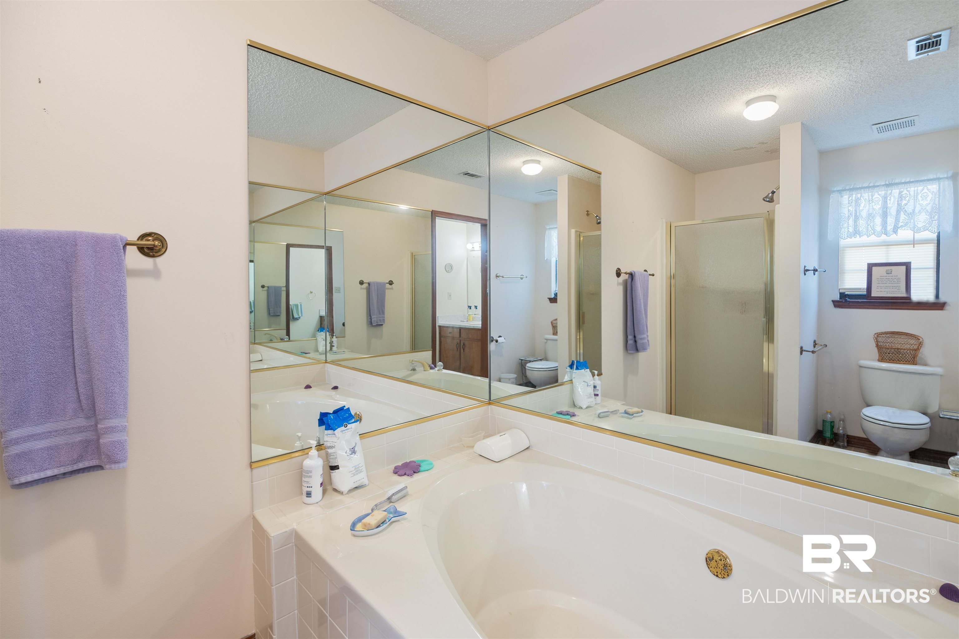 27321 Marina Road Orange Beach, AL 36561 - Photo 32 of 55 Bathroom with shower with separate bathtub, a textured ceiling, and toilet