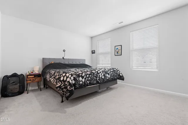 a bedroom with a bed rug and a window