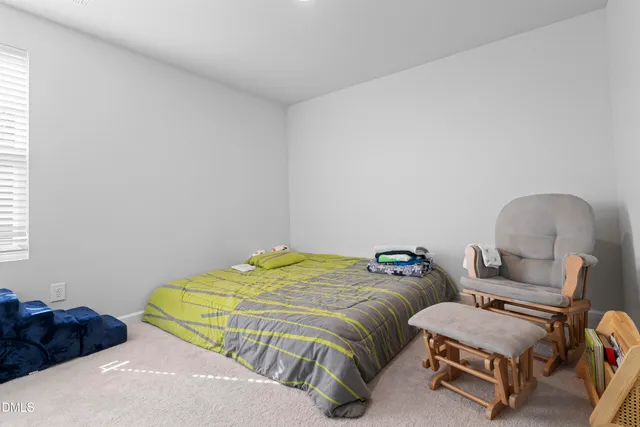 a bedroom with two beds and a dresser