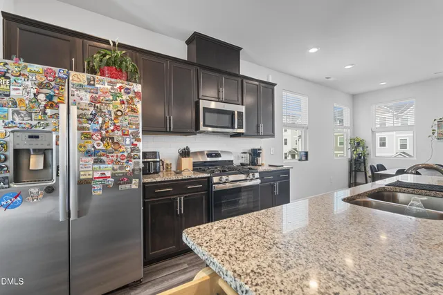 a kitchen with granite countertop stainless steel appliances and wooden cabinets