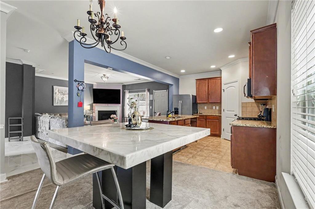 2780 Lakeview Walk Decatur, GA 30035 - Photo 15 of 37 a kitchen with stainless steel appliances kitchen island granite countertop a table chairs sink and stove