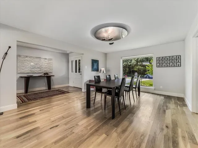 a kitchen with a refrigerator and white cabinets