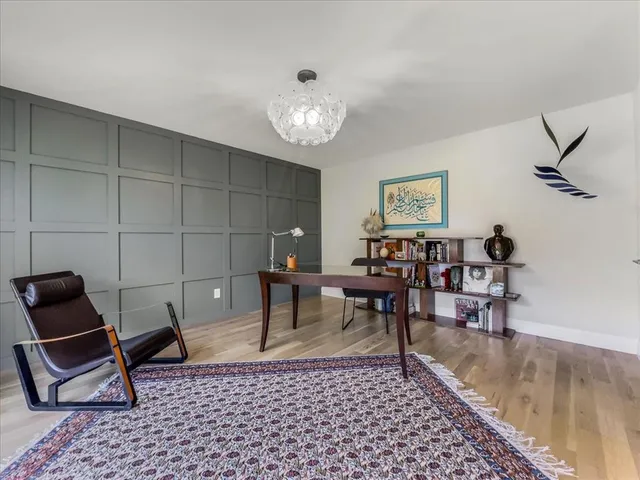 a view of a dining room with furniture a chandelier and wooden floor