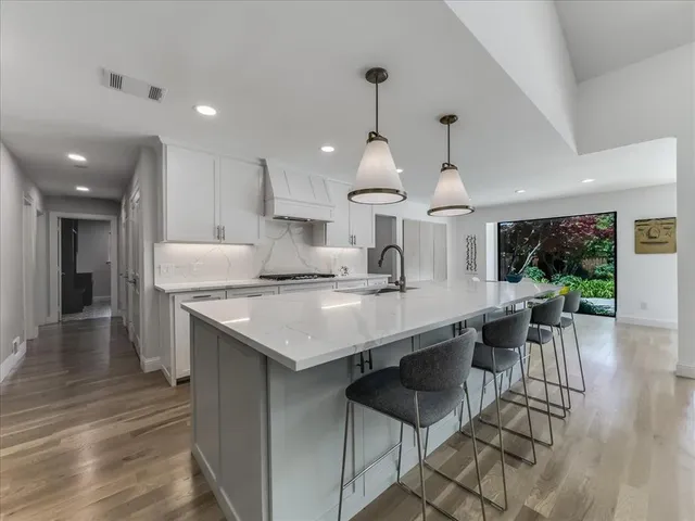a kitchen with stainless steel appliances granite countertop a stove and a refrigerator