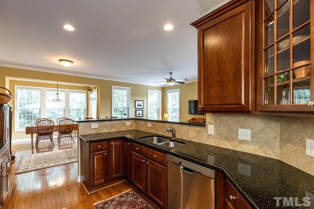 3512 Edgemont Drive Raleigh, NC 27612 - Photo 11 of 30 a kitchen with stainless steel appliances granite countertop a sink stove and cabinets