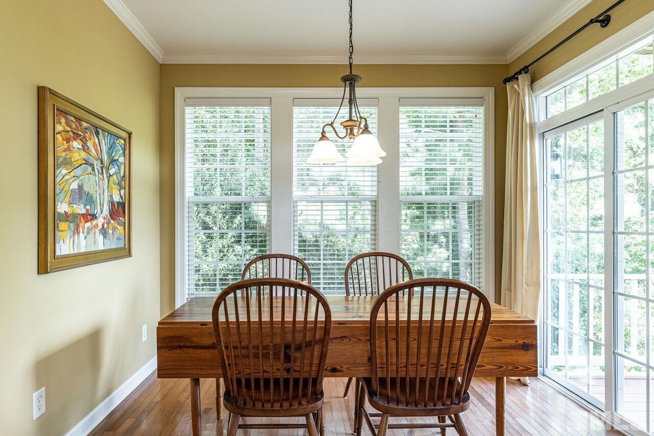 3512 Edgemont Drive Raleigh, NC 27612 - Photo 13 of 30 a view of a dining room with furniture window and wooden floor