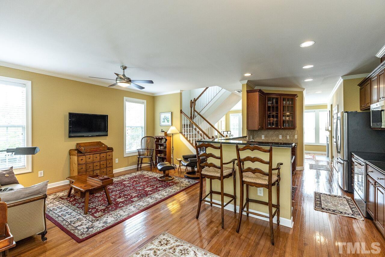 3512 Edgemont Drive Raleigh, NC 27612 - Photo 15 of 30 a living room with furniture a flat screen tv and a table